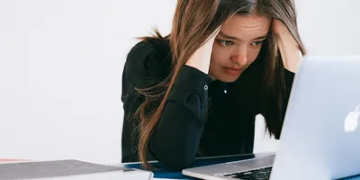 Mulher estressada olhando para um laptop — foto por Anna Shvets no Pexels
